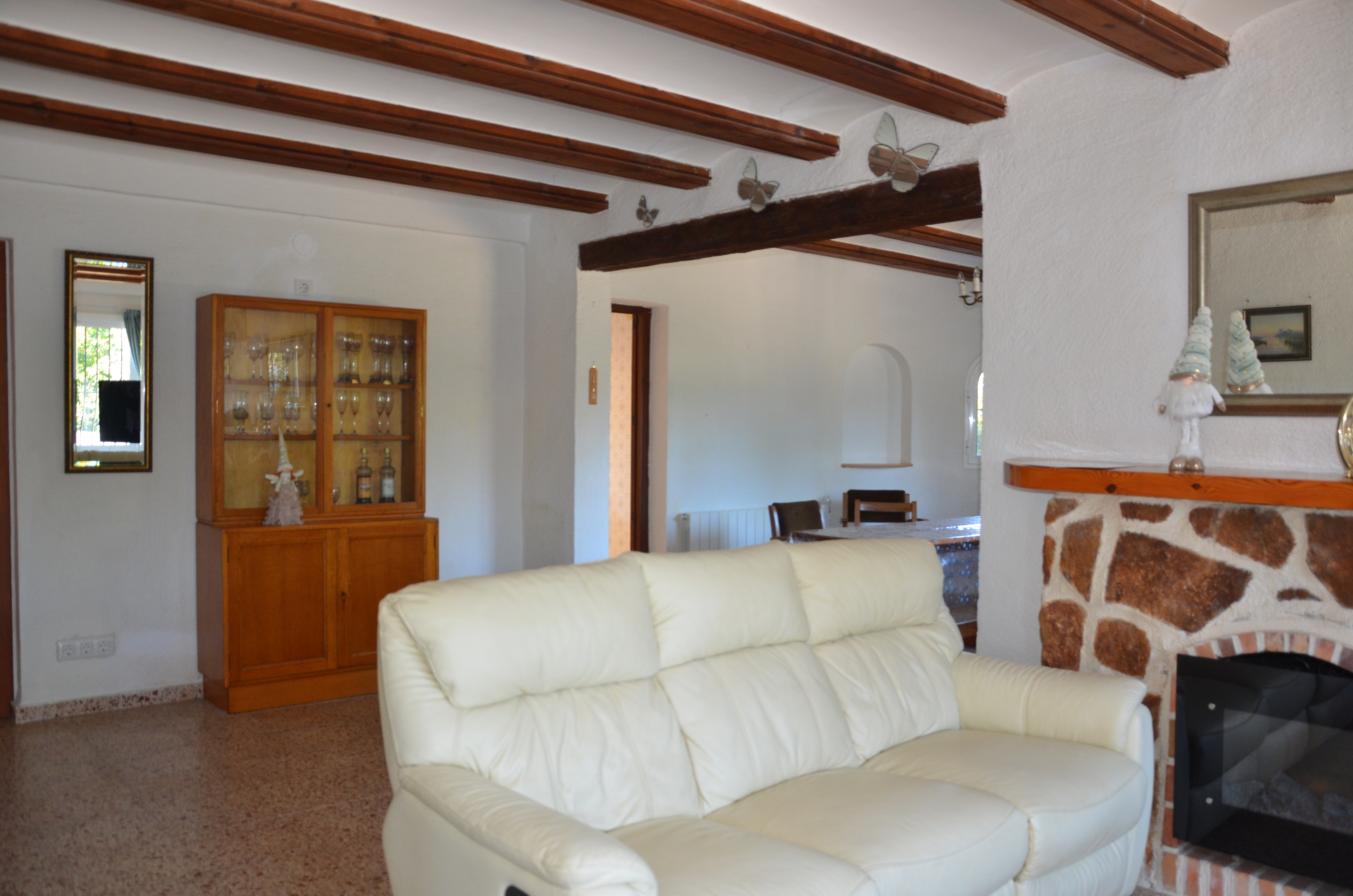 Living room with fireplace and cream sofas