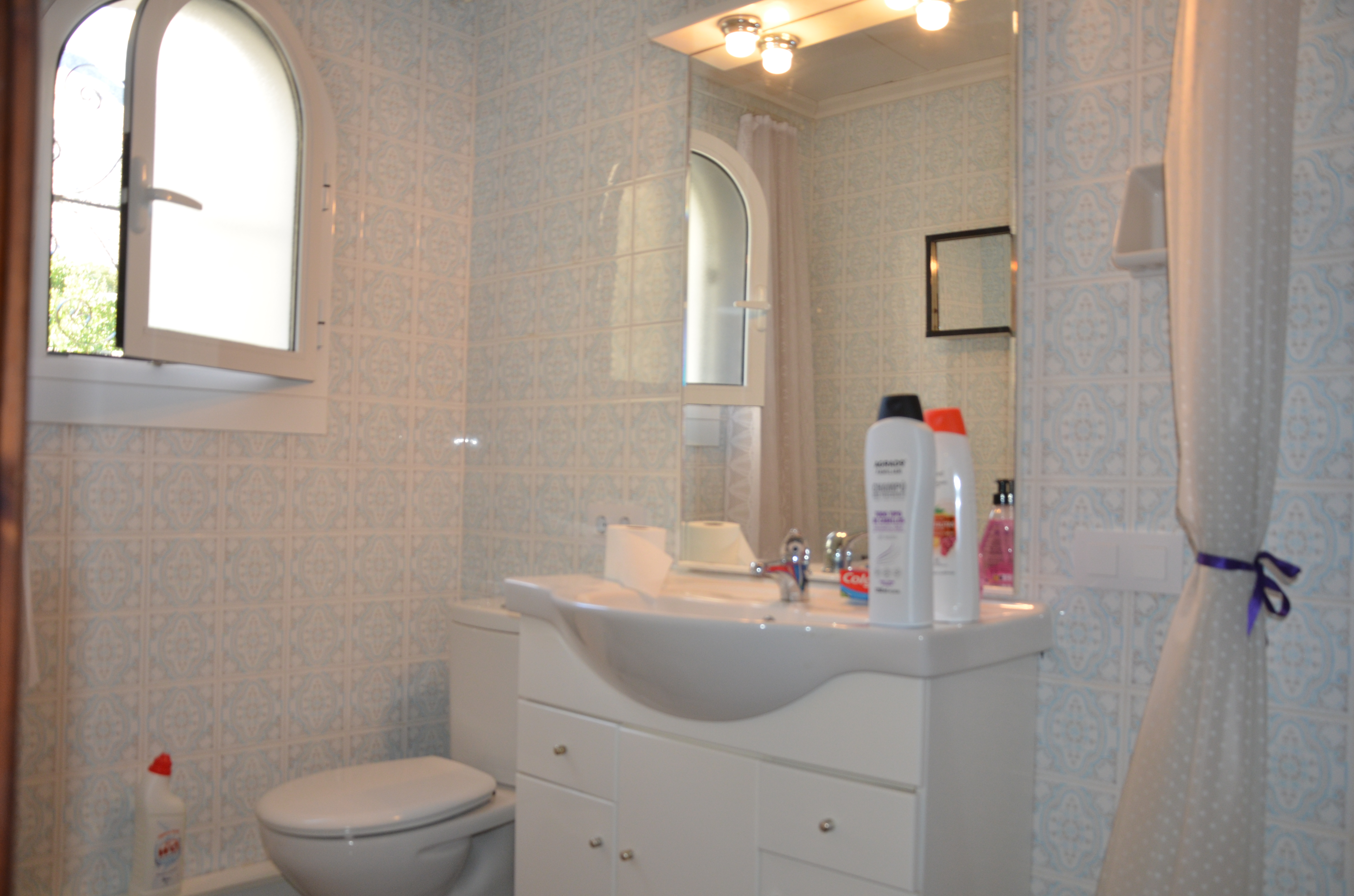 Bathroom with vanity and mirror