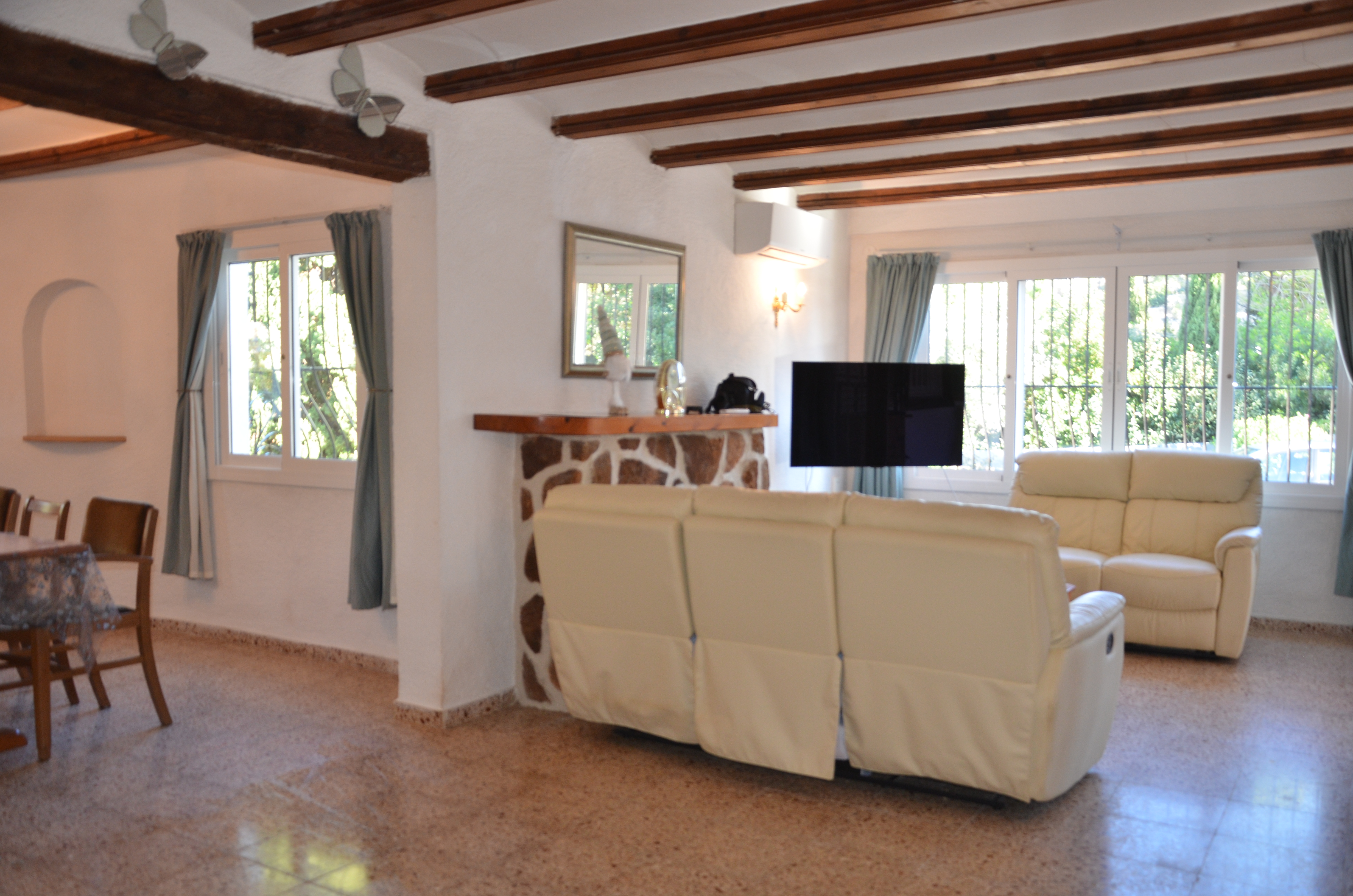 Spacious living room with TV and fireplace