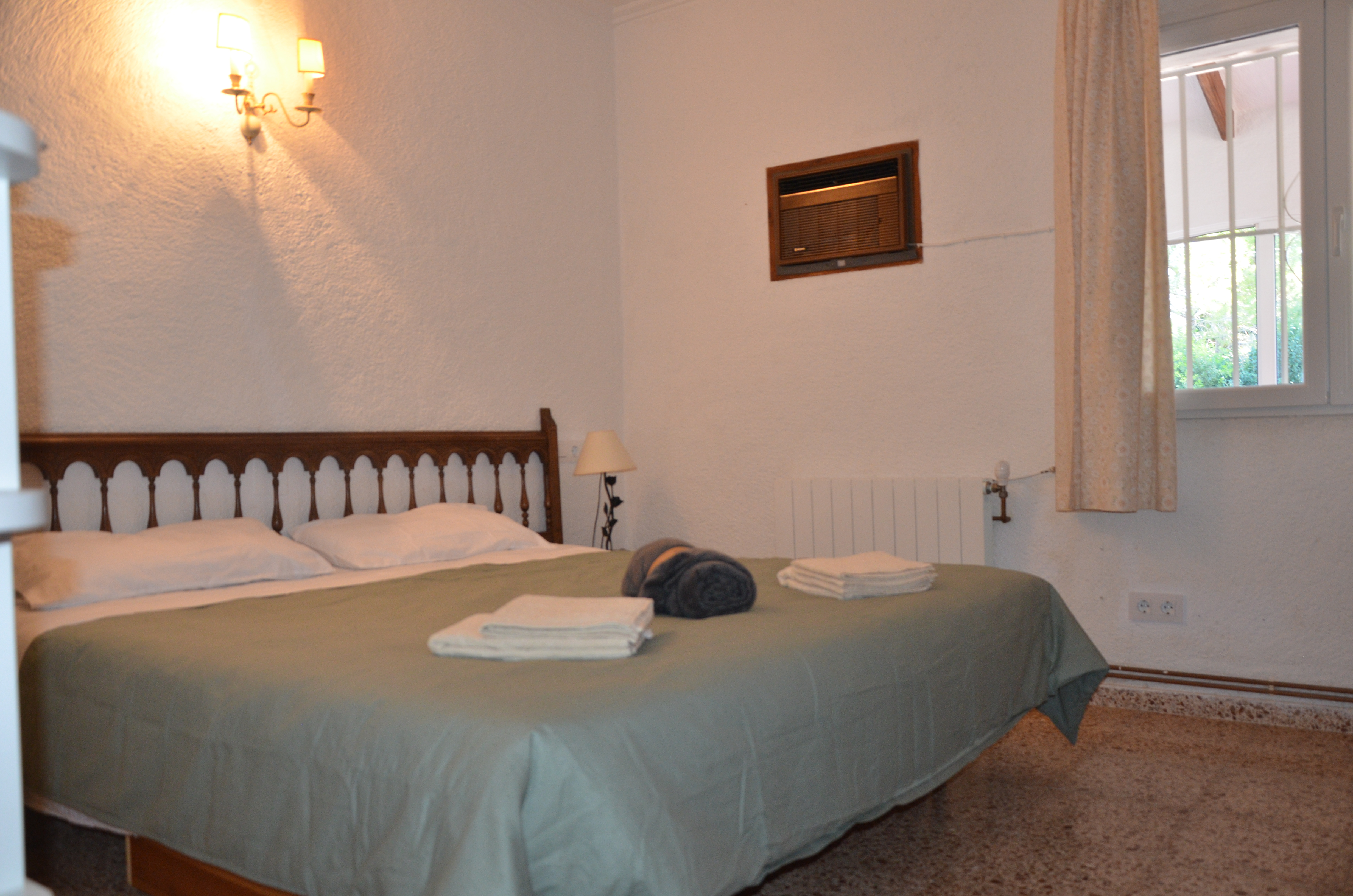 Bedroom with garden view and wall sconces