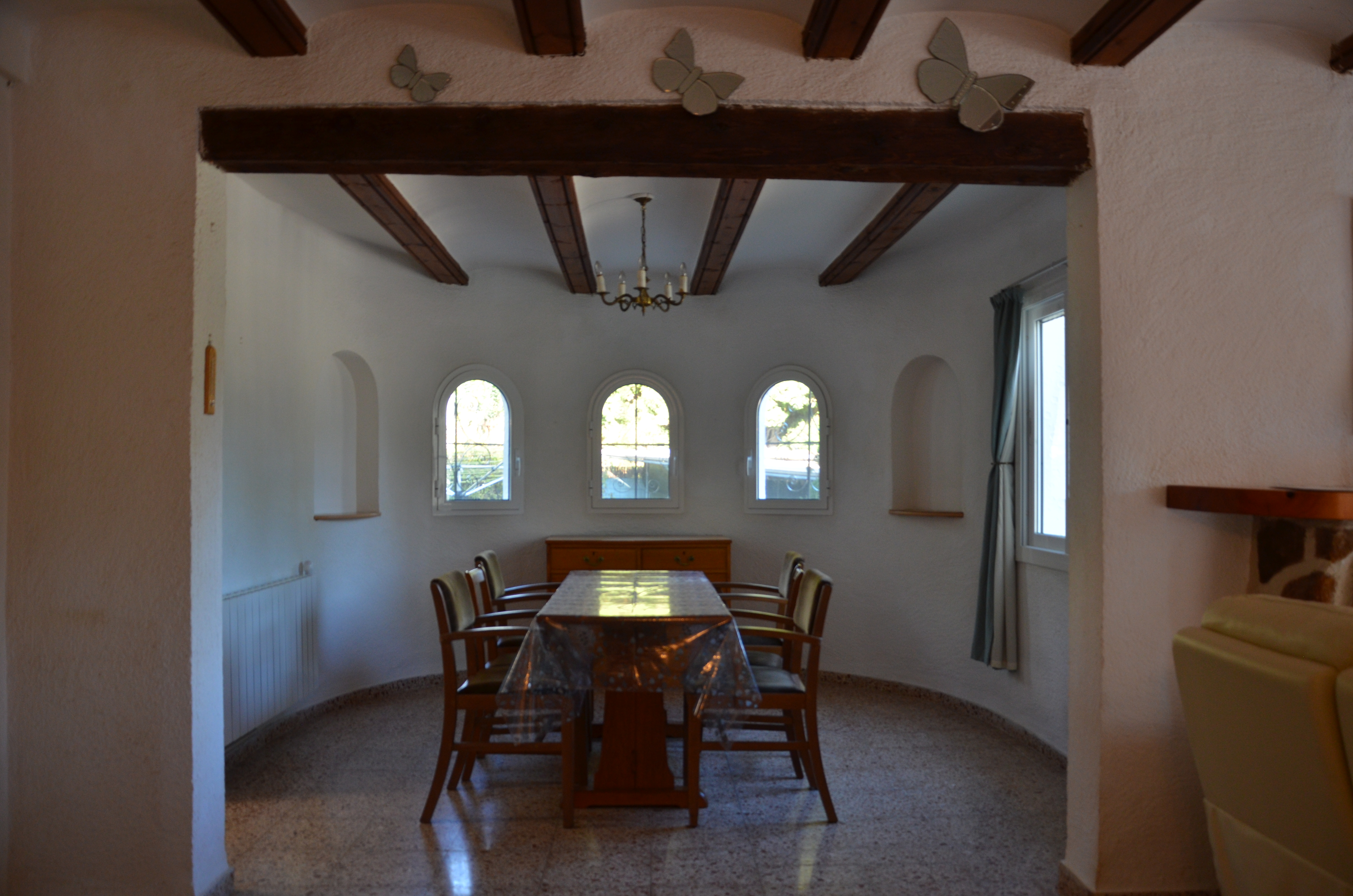 Dining area with arched windows and chandelier
