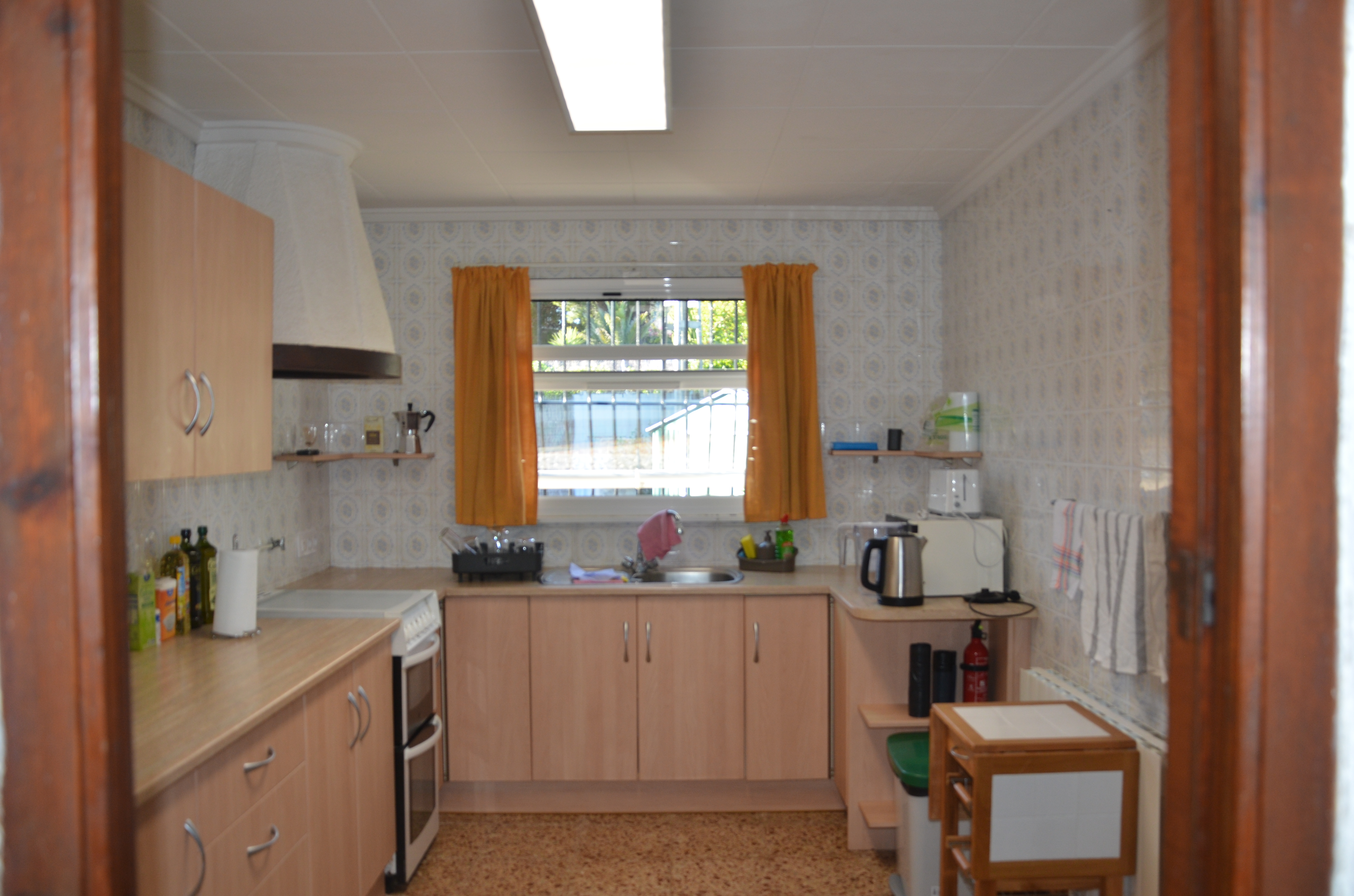 Kitchen with wooden cabinets and garden view