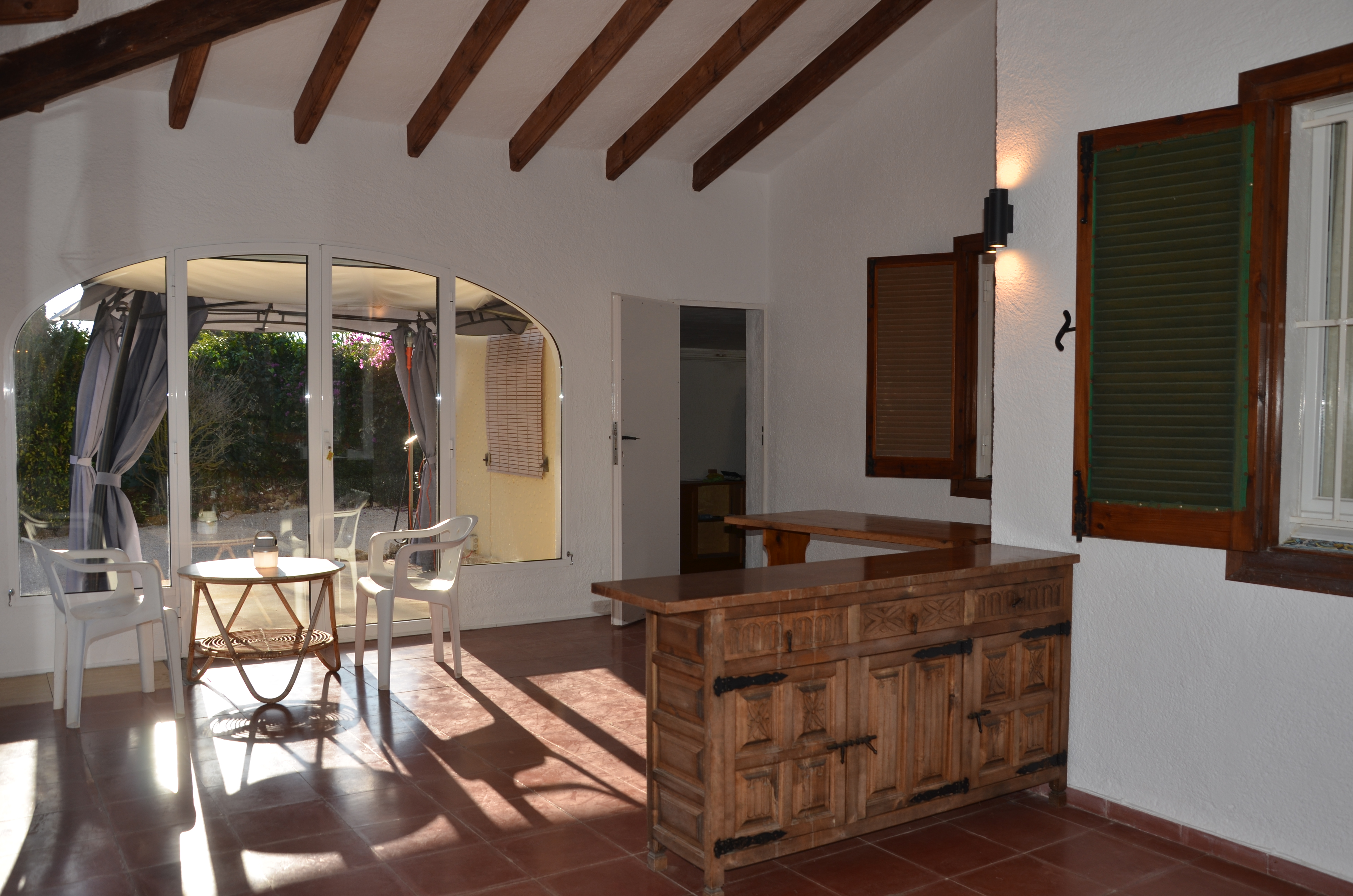 Covered terrace with rustic wooden cabinet