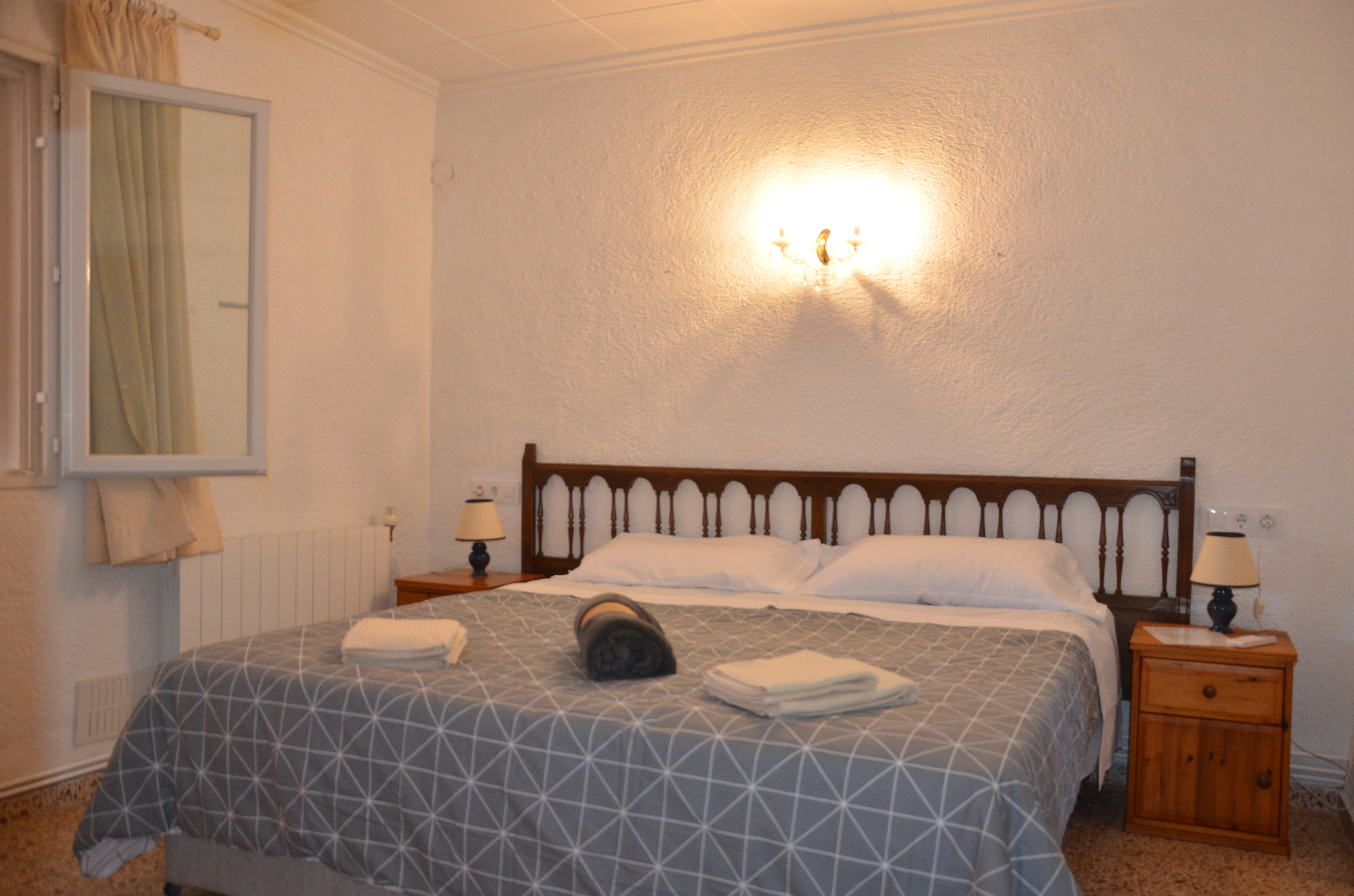 Bright bedroom with wooden headboard